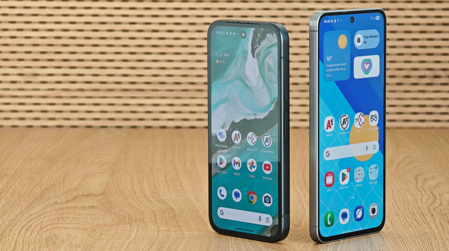 Pixel 9a und Galaxy A56 stehend vor braunem Hintergrund